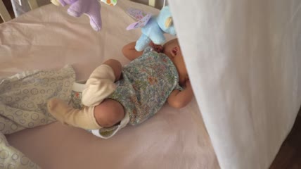 不安分的婴儿躺在床上特写实拍
