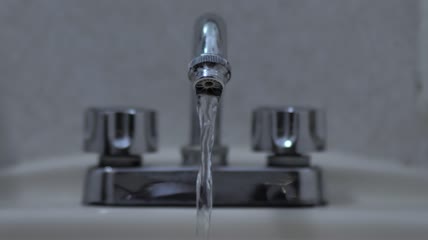 水从水槽里的水龙头里流出来