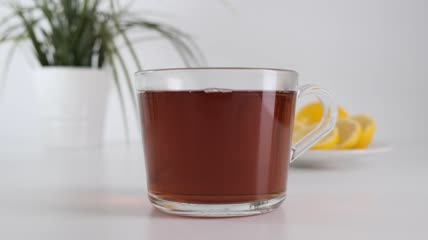 把热茶倒进桌上的玻璃杯特写实拍